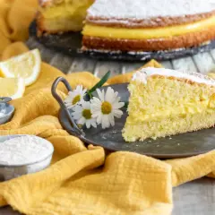 Una fetta di torta paradiso, soffice e farcita di crema, pronta per essere gustata. La ricetta perfetta per un dolce fatto in casa.