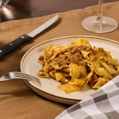 Piatto di pappardelle al cinghiale, un classico della cucina toscana, pronto per essere gustato.