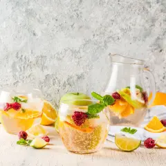 Sangria bianca ricetta: bicchieri e caraffa pieni di frutta fresca, ghiaccio e menta. Perfetta per l'estate!