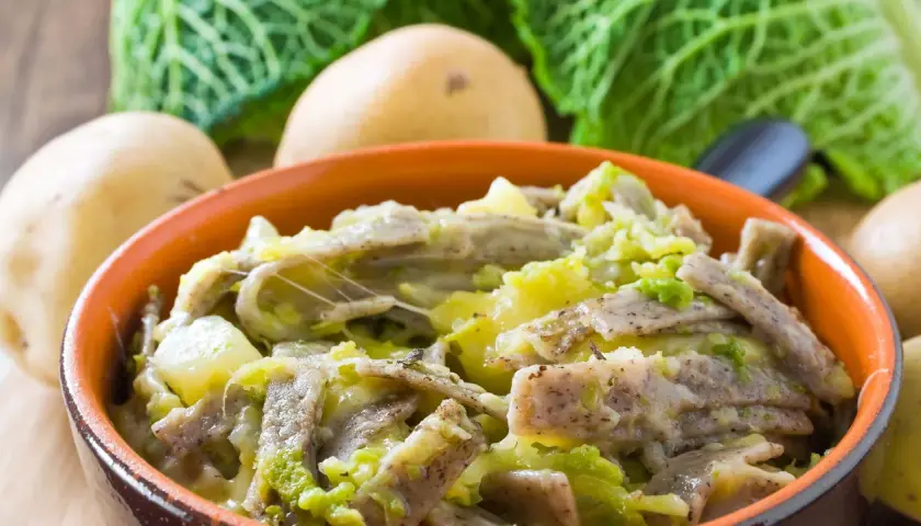 Piatto fumante di pizzoccheri alla valtellinese, con patate, verza e formaggio filante.