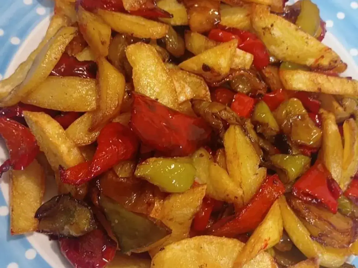 Un piatto invitante di patate fritte croccanti e peperoni colorati, un classico contorno di pipi e patate.